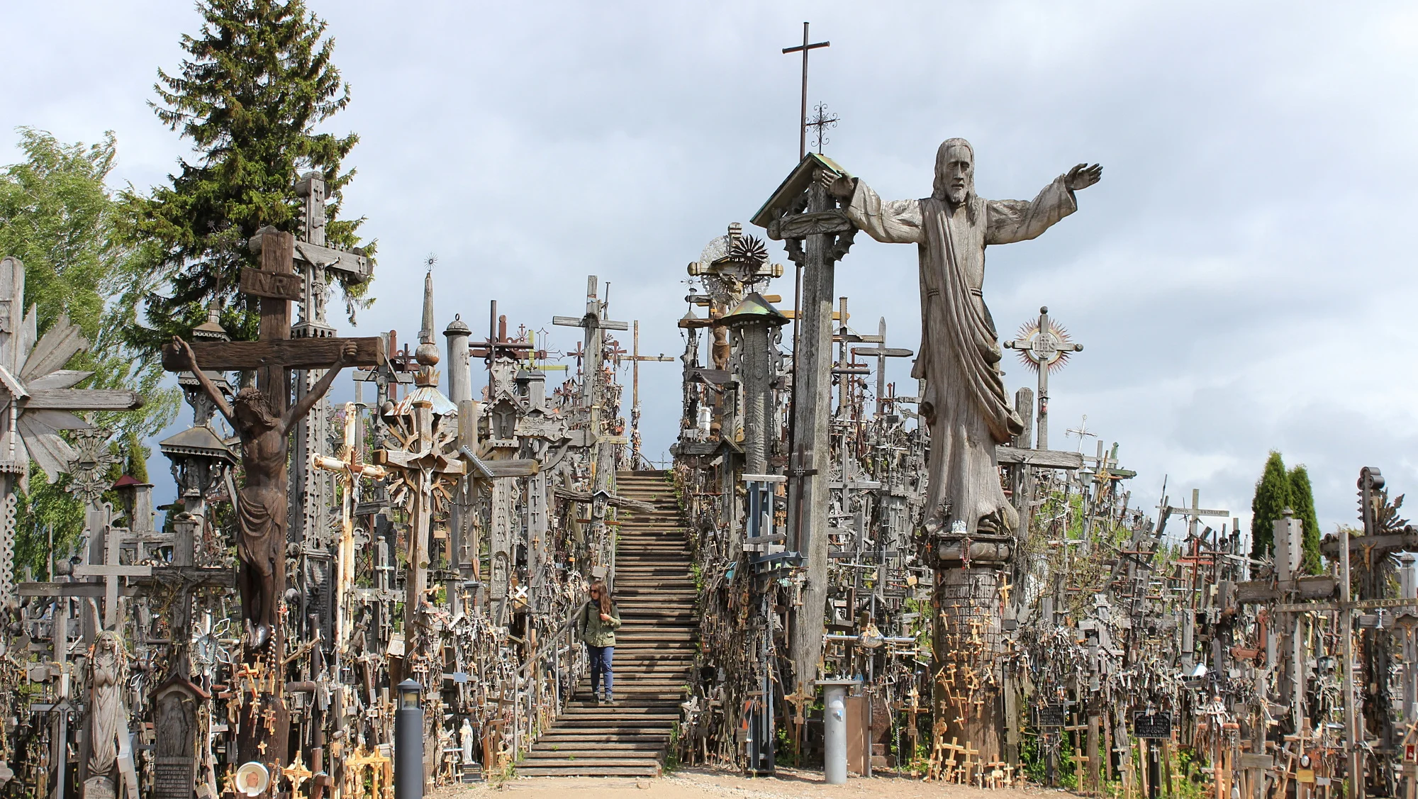 Thousands of crosses on a hill with a stairway in the middle.