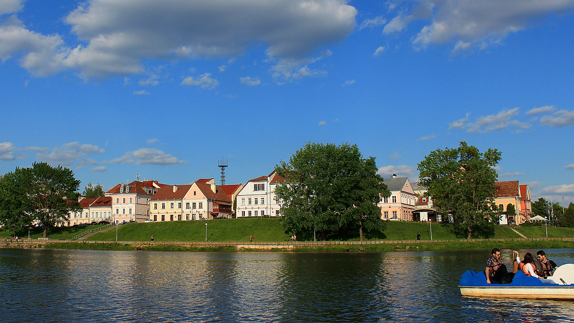 Troitskoye Predmestie or the Trinity Suburb is the old town of Minsk. Pictured on a beautiful sunny day with the river in front. Hostel Trinity is one of the few hostels for backpacking in Belarus.