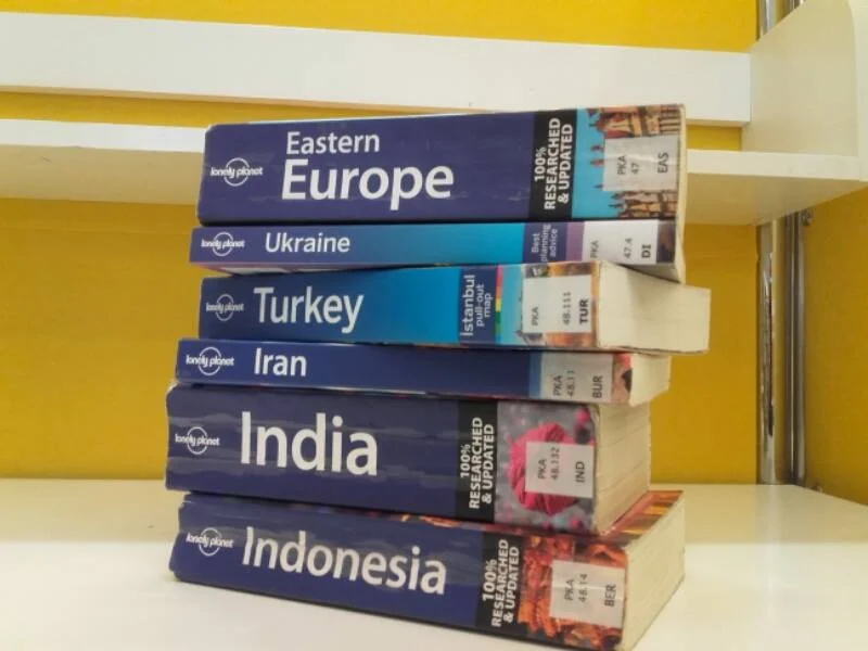 A pile of Lonely Planet guidebooks. Preparing for long-term travel may demand more research.