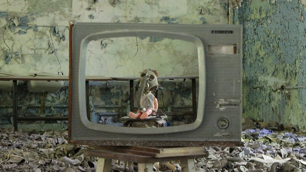 A creepy baby doll with a gas mask inside a television in Pripyat near Chernobyl.