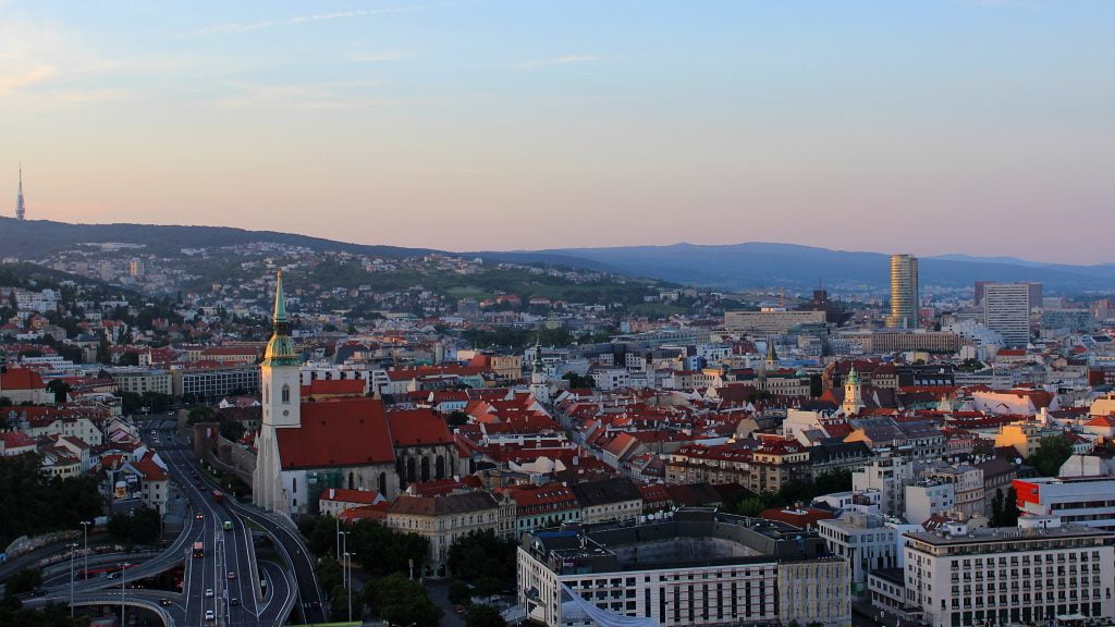 Reasons for traveling in Eastern and Central Europe. The Old Town of Bratislava, Slovakia at sunset from the UFO bridge tower.