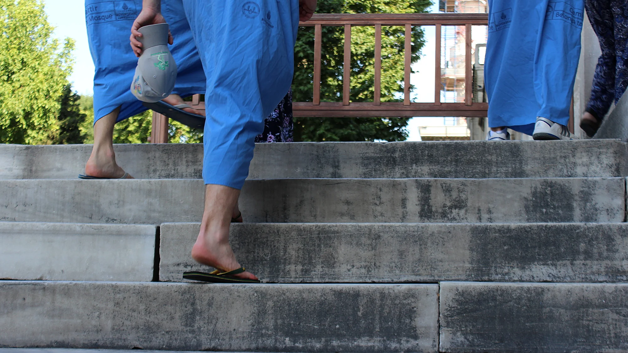 Entering blue mosque without shoes and shorts with blue dresses.