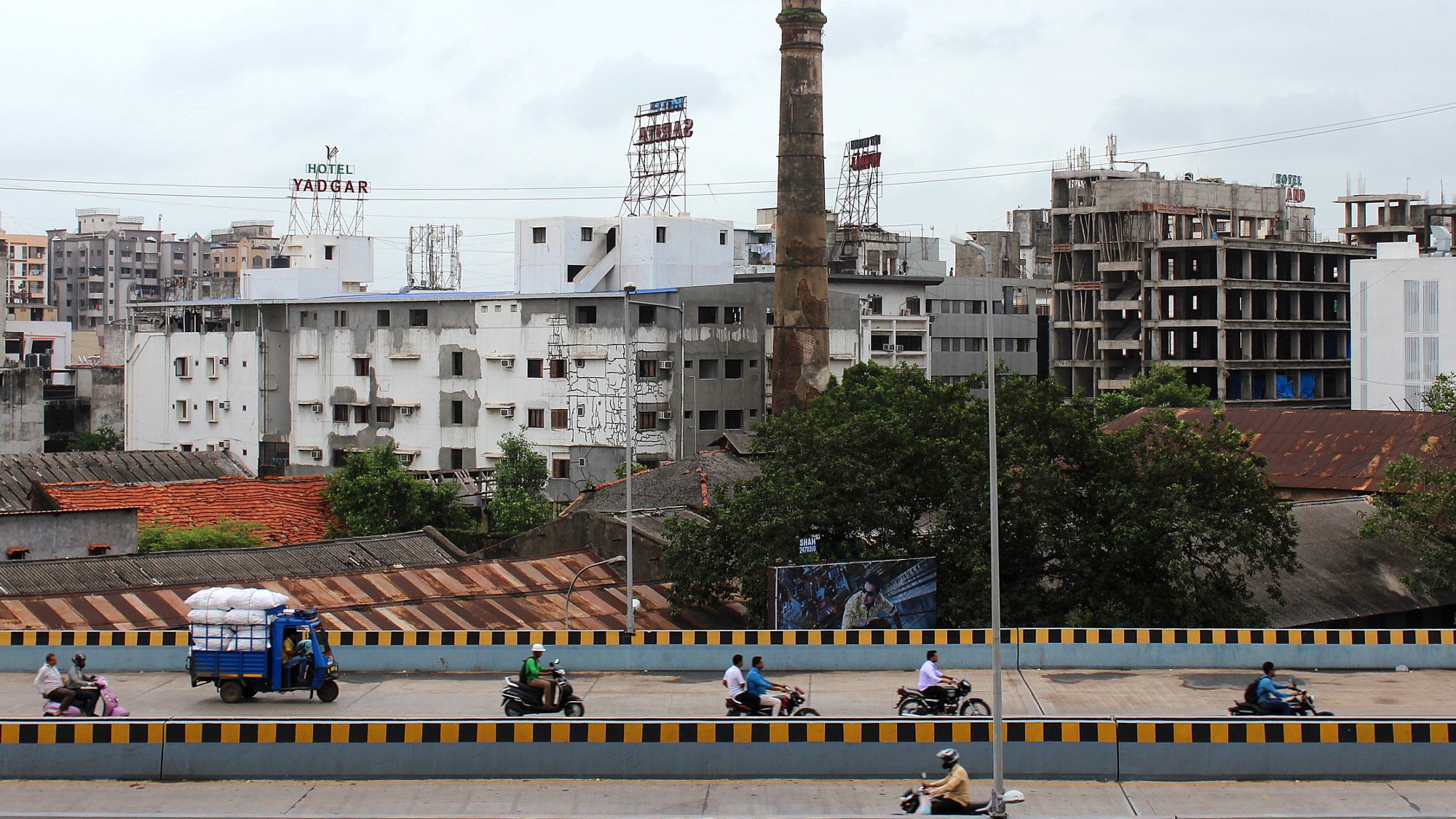 Surat, a random city in India. A main road with motorbikes in Surat photographed from the side.