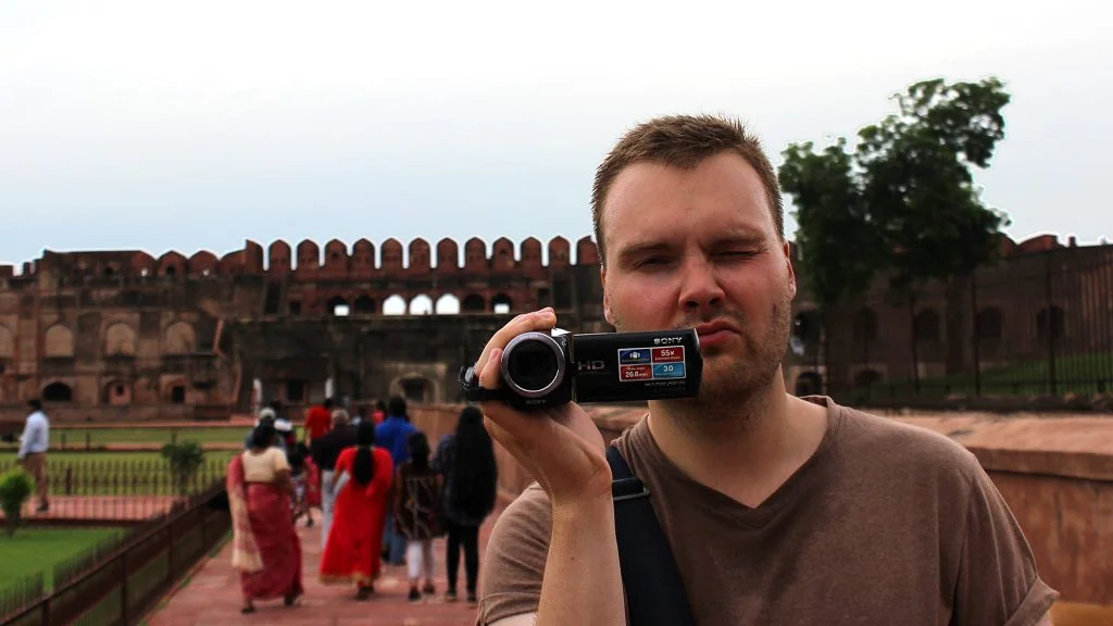 A Western tourist pointing a video camera to the photographer in Agra Fort.