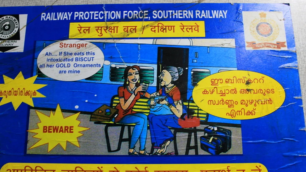 Survival tips for India: an official sign warning about "intoxicated BISCUTS" on a train in India.