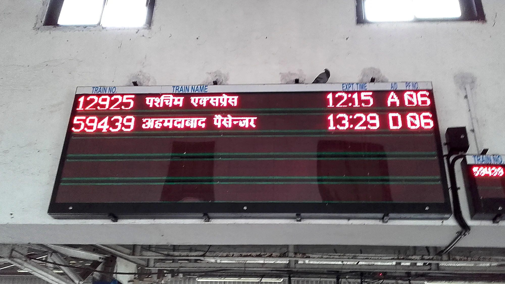 Train timetable with writing in Hindi in Mumbai.