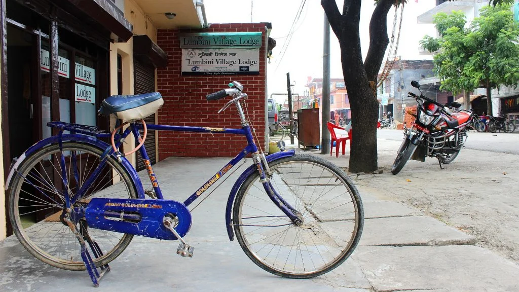 A rented blue bicycle in Lumbini Bazaar in front of Lumbini Village Lodge. My stay after crossing the Lumbini to India border between Nepal and India.