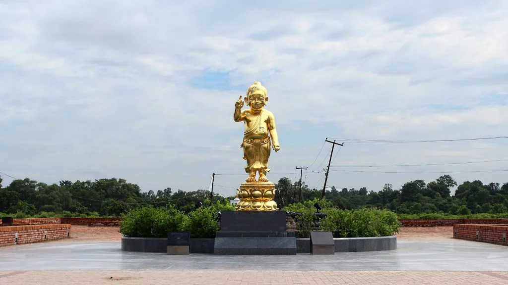 A rare golden statue of baby Buddha pointing a finger up in the sky in Lumbini.
