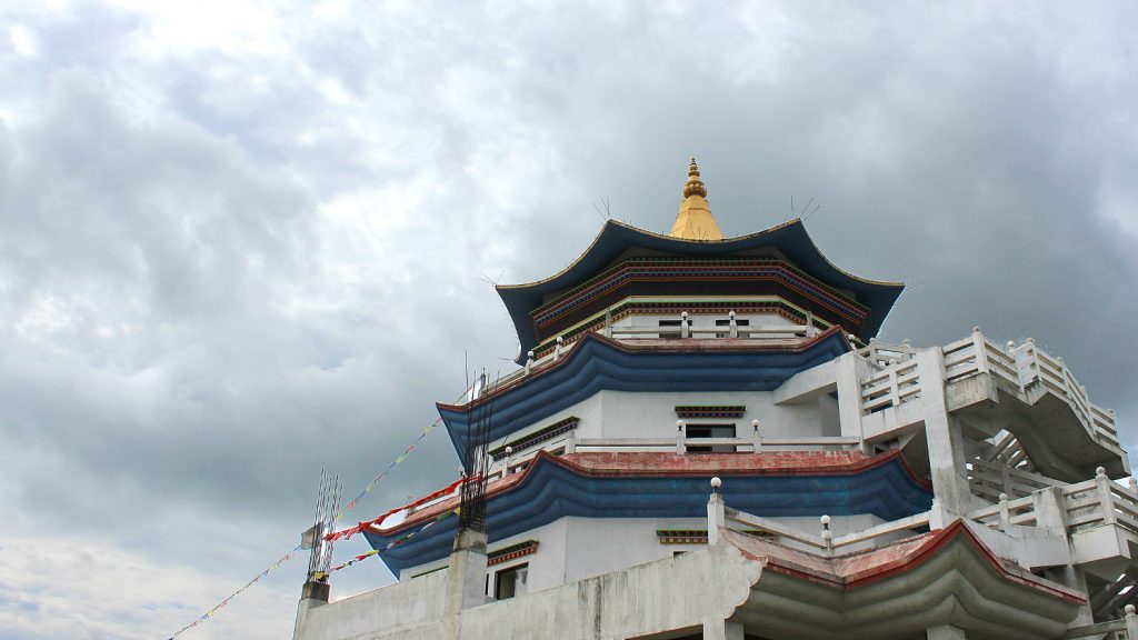 The white and blue tower of a monastery in Lumbini.