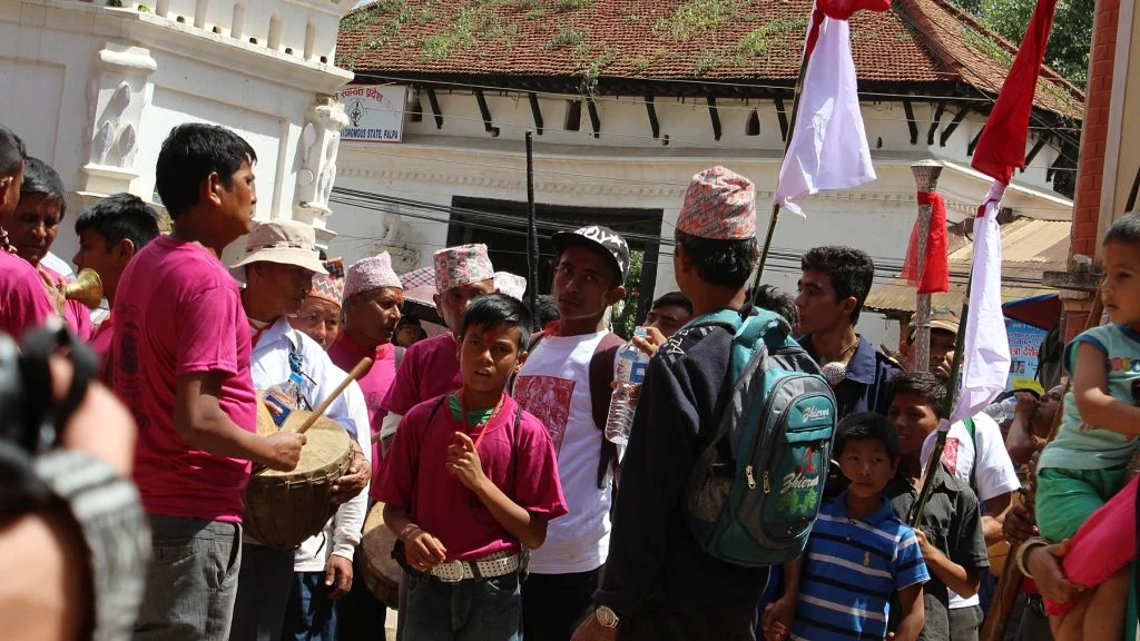 A traditional Hindu festival with people playing instruments in the center of Tansen Nepal.