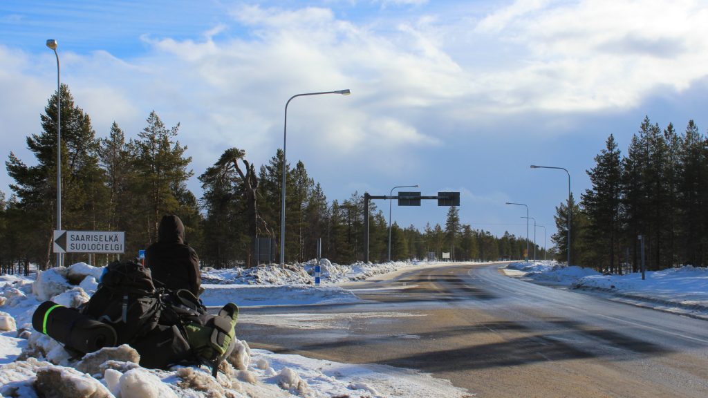 A backpacker hitchiking near Saariselkä in Lapland, Northern Finland.