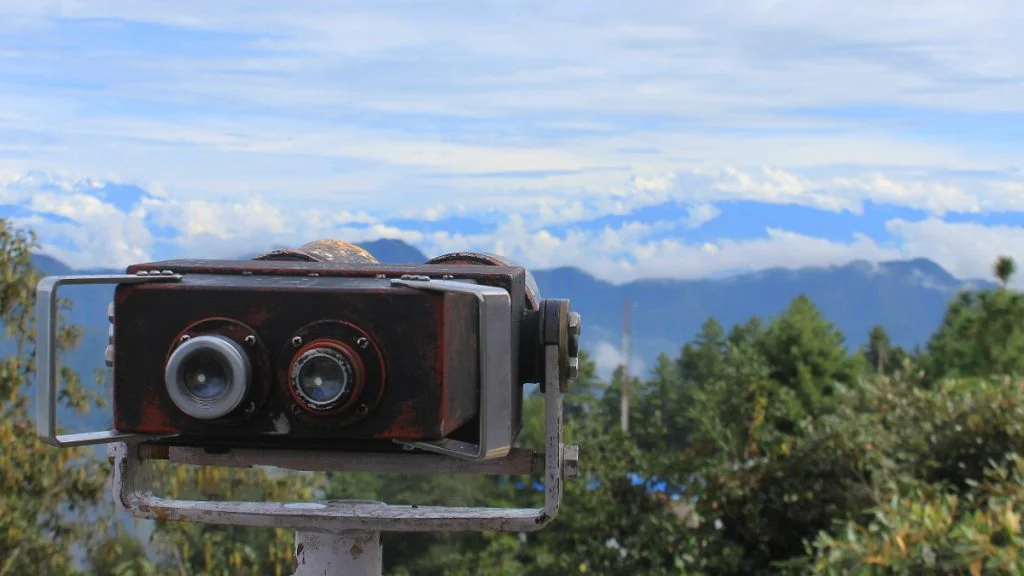 Best places to see the Himalayas in Nepal. Binoculars in the view tower of Daman, Nepal with the Himalayas in the background.