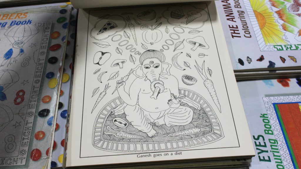 A Ganesh colouring book showing the elepant god Ganesh going on a diet. The god eats vegetables, but dreams od pizza and ice cream. Book on sale in Pilgrim Book House.