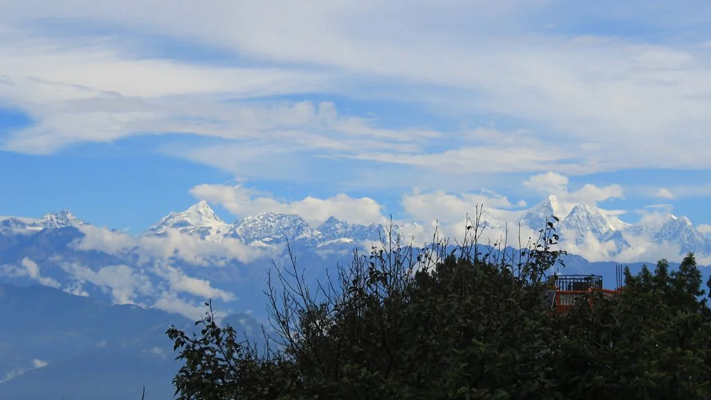 A glimpse of the Himalyas from the yard of Hotel at the End of the Universe, Nagarkot. One of the best views of the Himalayas from Nepal.