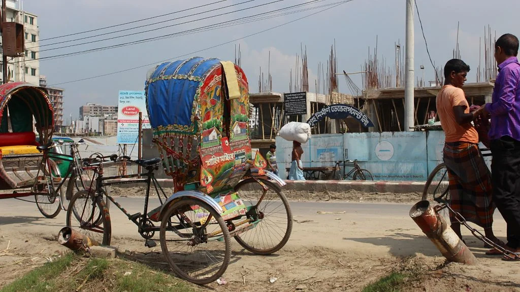 A cycle rickshaw by the side of the road in Bangladesh.