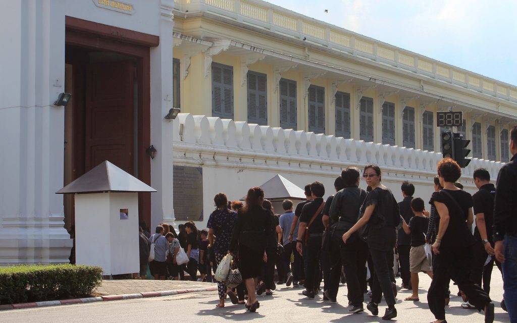 Mourners of the late king Bhumibol march to the Grand Palace in Bangkok, Thailand. All people are wearing either black or white.