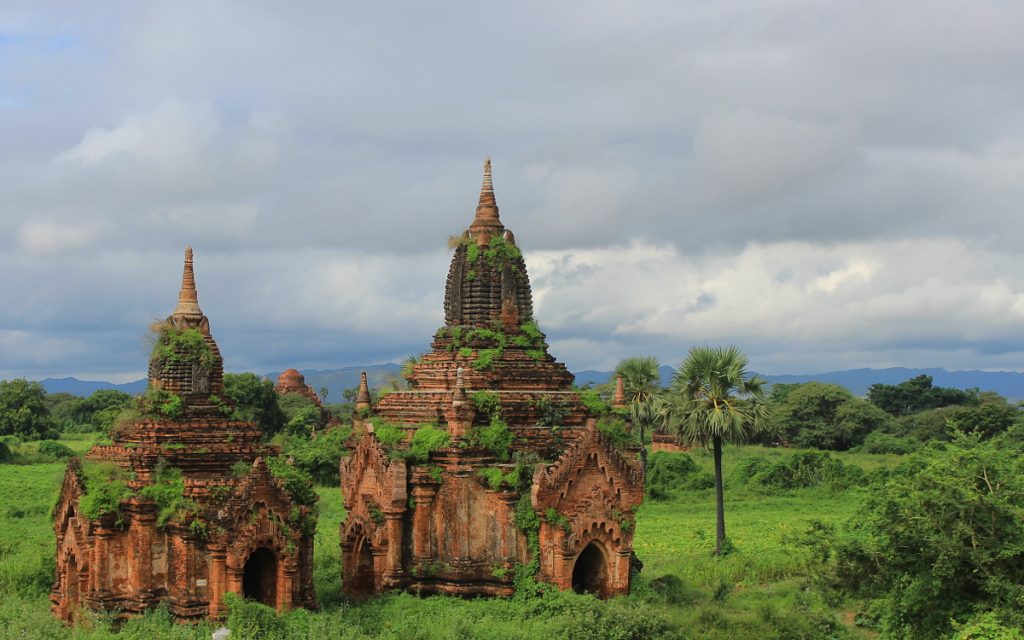 Two small temples in Bagan, Myanmar slightly covered in moss.