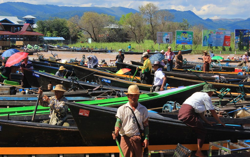 Boat tour to Inle Lake. Dozens of boatmen and longboats in a dock in Inle Lake, Myanmar.