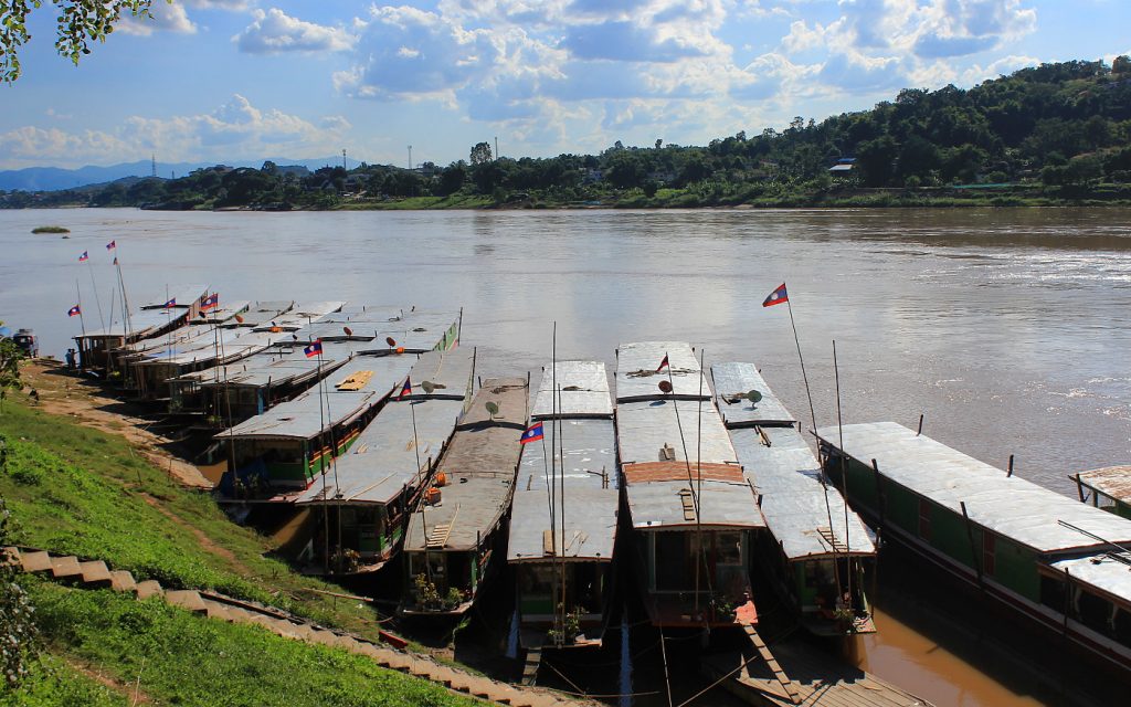 Slow boats waiting at the harbour of Huay Xai, Laos.