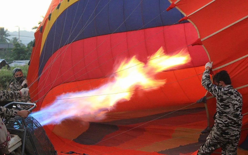 Inflating a hot air balloon with a giant flame.