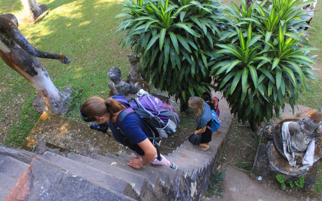 Two German backpackers climing steep stairs in Buddha Park (Wat Xieng Khuan).