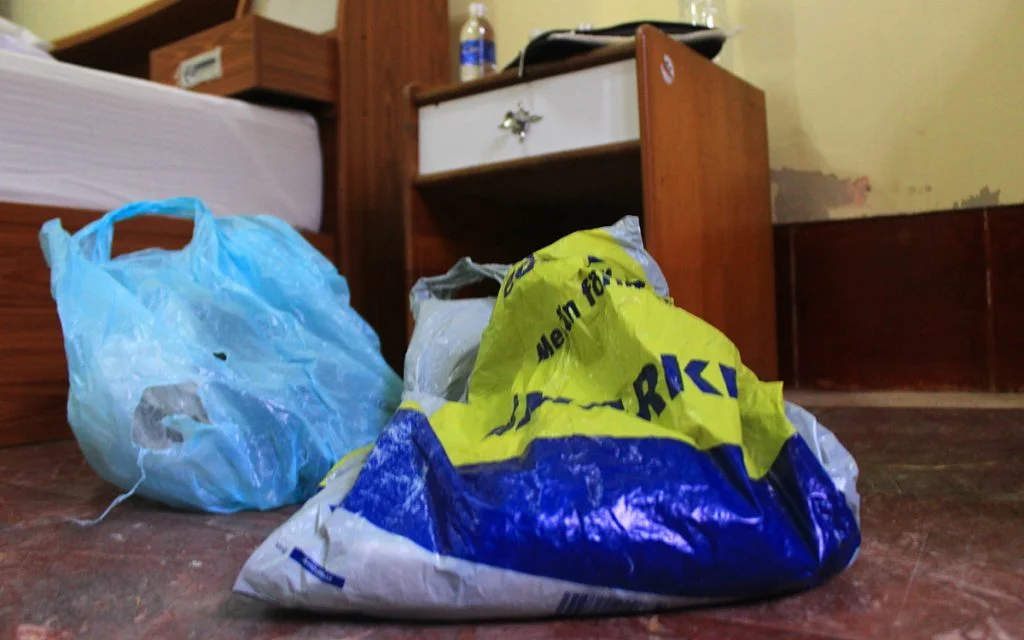 A finnish S-market plsatic bag on the floor of a hote in Laos.