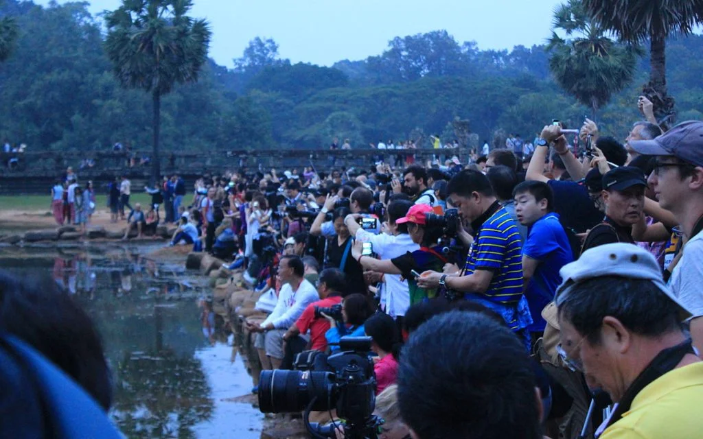 Tourist crowd waiting for sunrise at Angkor Wat.