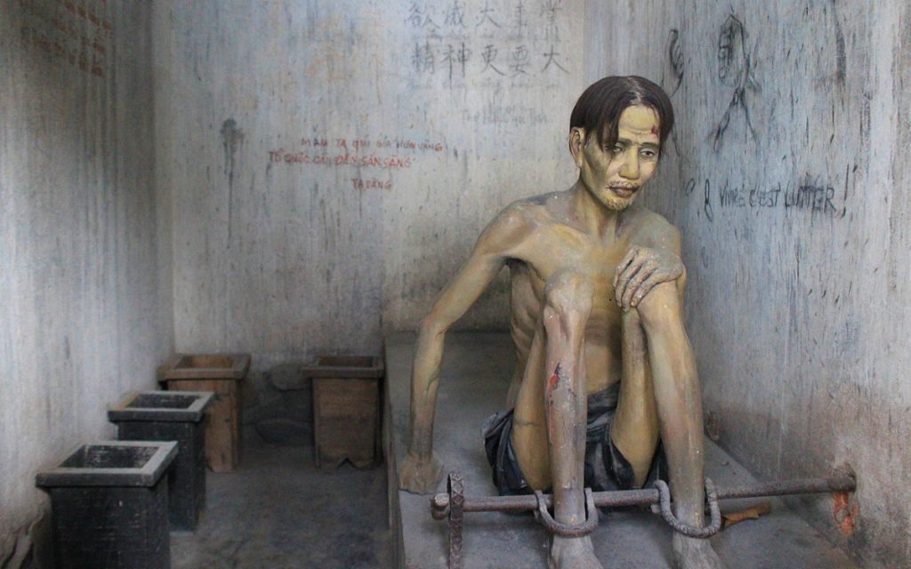 A dummy war prisoner in a reconstruct American prison room from Vietnam War era.