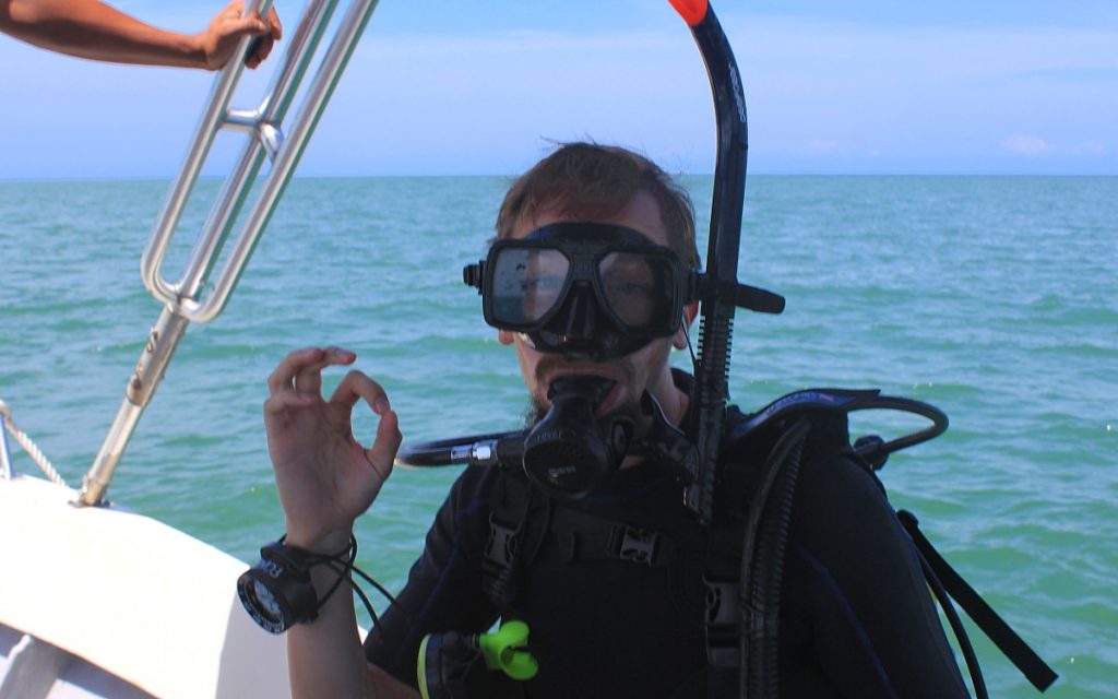 Diver giving the OK signal on the boat.