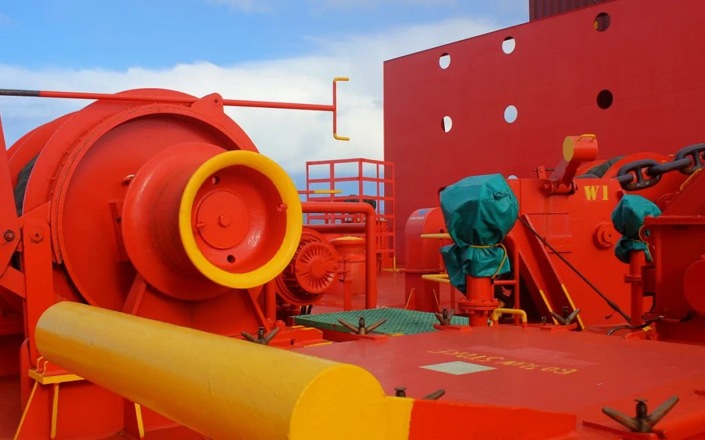 Red structures on the front of a cargo ship.