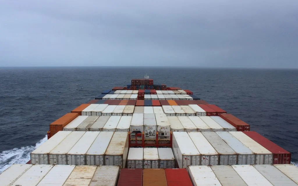 A cargo ship surrounded by grey clouds.