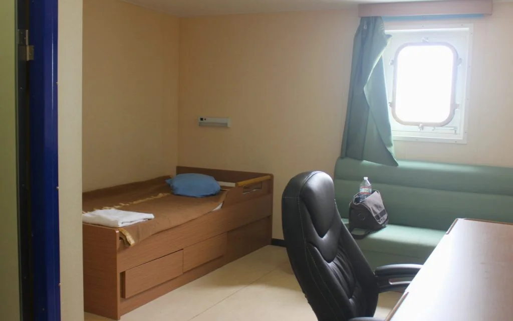 A basic cargo ship cabin used while traveling on a cargo ship as a passenger.