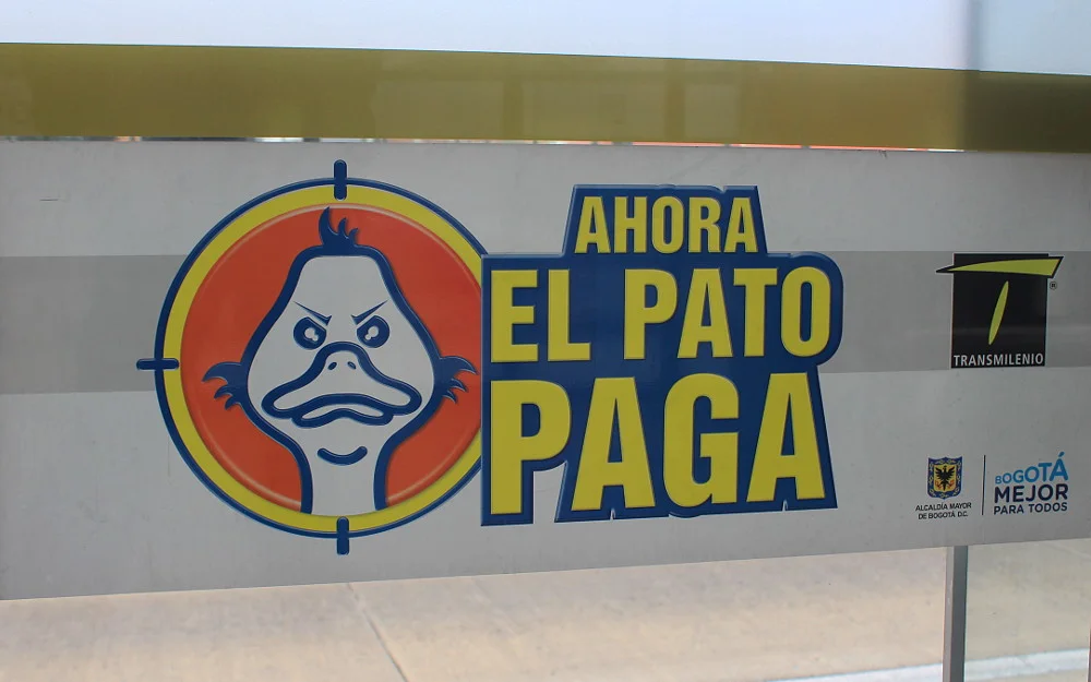 Ahora El Pato Paga sign on TransMilenio Rapid Transport System, Bogotá. Curious things about Colombia.