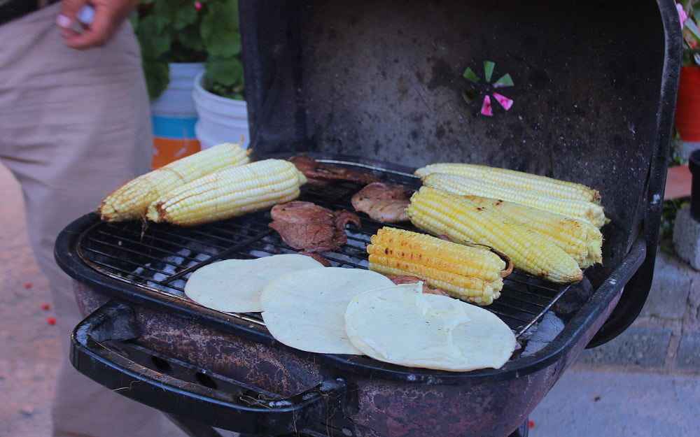 Mexican tortillas and corn on a grill.