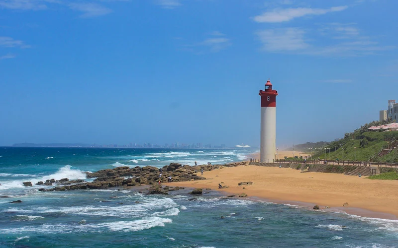 Umhlanga Rocks lighthouse with downtown Durban in the background.
