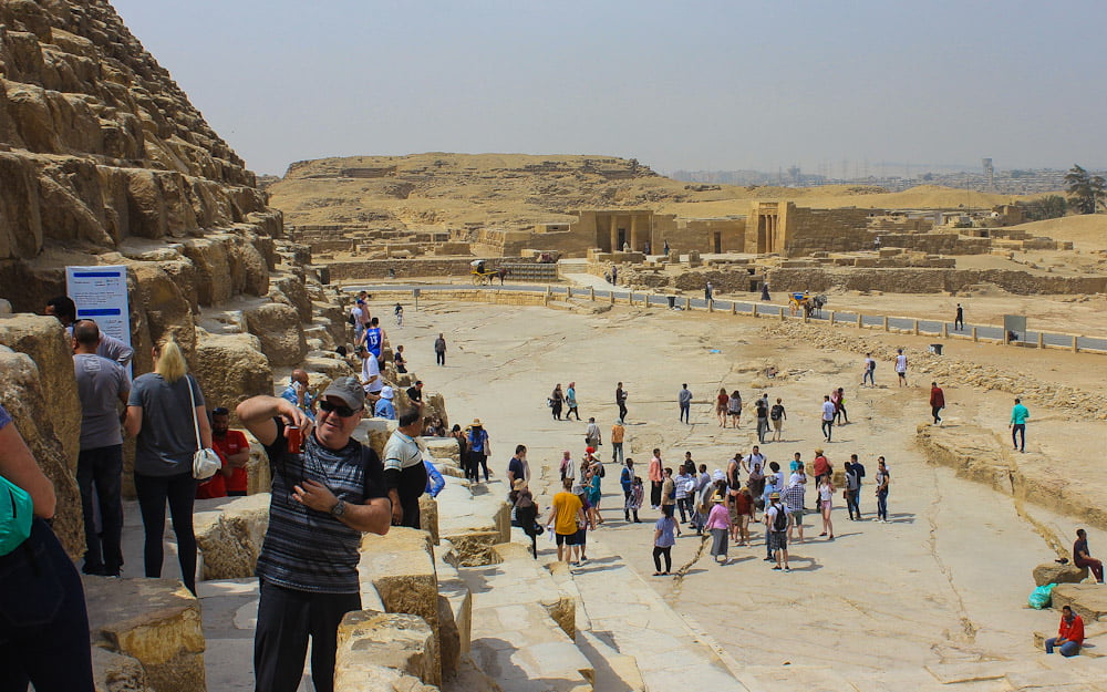 Tourists climbing on the Great Pyramids of Giza in 2018. Visiting Cairo, Egypt in 2018.