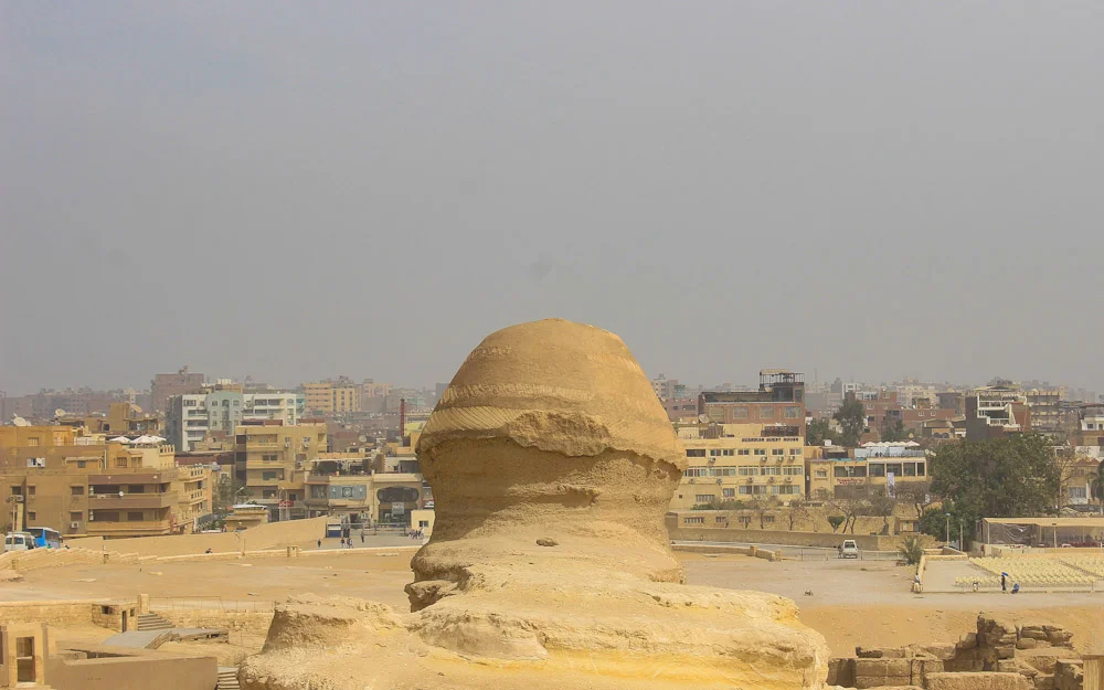 The Sphinx of Giza from behind with heavy smog in the background.